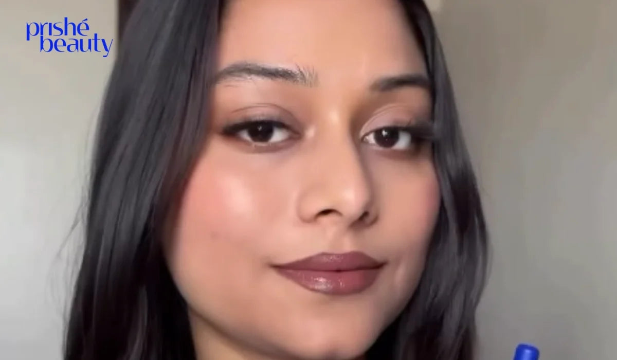 Woman with a natural makeup look featuring glowing skin, soft blush, subtle eye makeup, and natural pink lips.